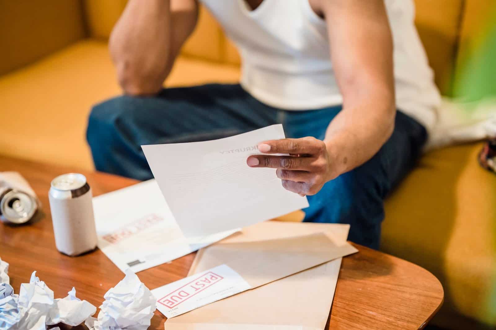 Life insurance policy papers and envelopes on a table by a sunny window