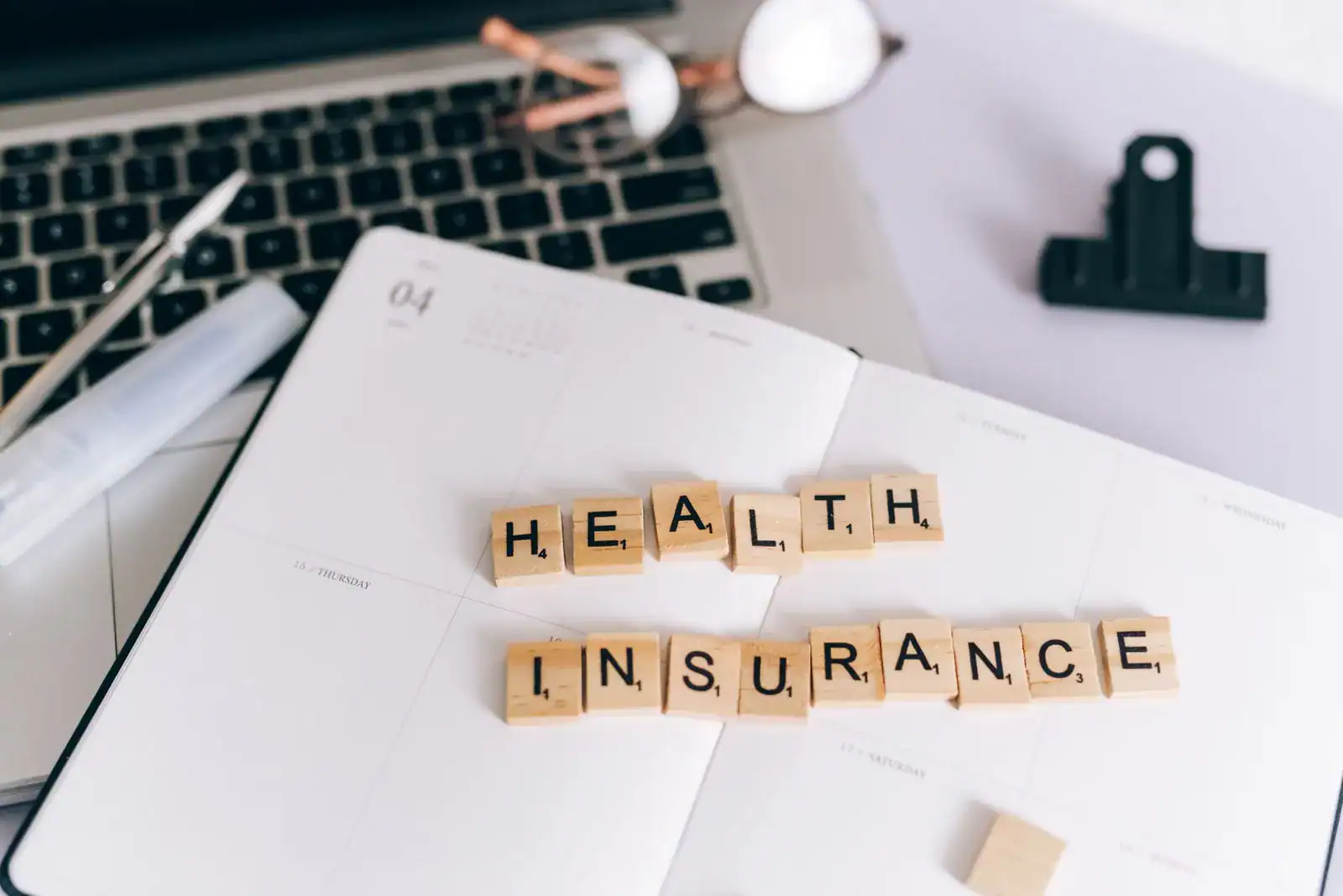 Stacked folders and stethoscope illustrating life insurance health class tiers